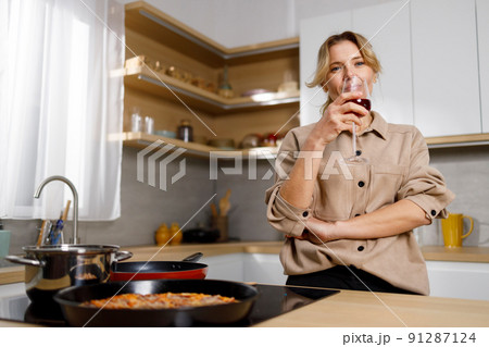 Mature pretty woman relaxing and drinking wine...の写真素材 [91287124] - PIXTA