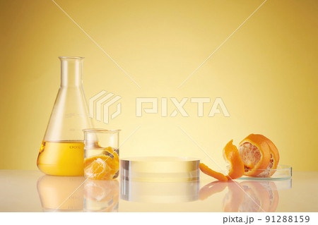 Front view of orange decorated with glassware and transparent podium in brown background 91288159