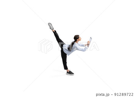 Portrait of female office worker standing on twine and making business notes isolated over white studio background Portrait of female office worker standing on twine and making business notes isolated over white studio background 91289722