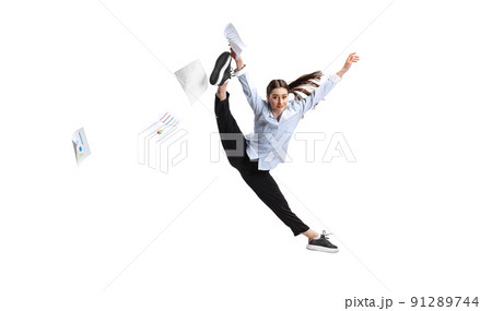 Portrait of female employee, office worker throwing papers in jump isolated over white background. Vacation time 91289744