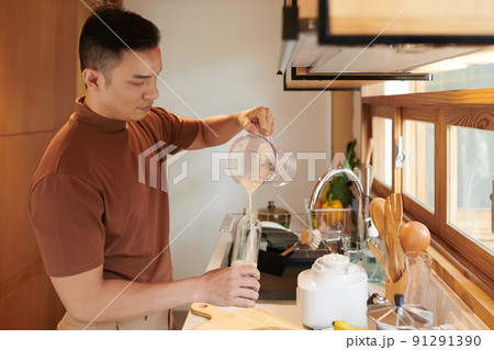 Man Pouring Milkshake in Bottle Man Pouring Milkshake in Bottle 91291390