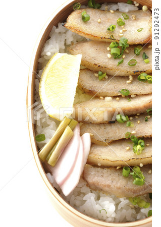 曲げわっぱに漬物とカットレモンと豚トロが入っている焼肉弁当を白背景で俯瞰撮影 91292473
