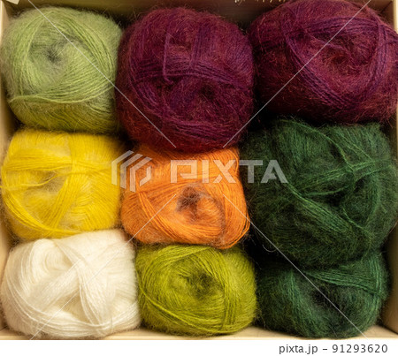 Close Up of yarn balls. Rainbow colors. Yarn for knitting. Skeins of yarn. Knitting needles, colorful threads. Knitting background, Knitting yarn for handmade winter clothes Close Up of yarn balls. Rainbow colors. Yarn for knitting. Skeins of yarn. Knitting needles, colorful threads. Knitting background, Knitting yarn for handmade winter clothes 91293620