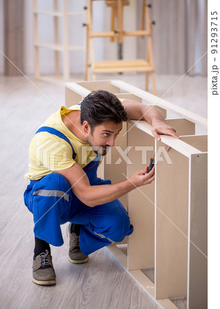 Young male carpenter working at home 91293715