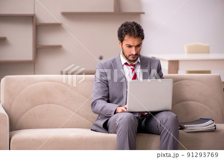 Young male employee working from home during pandemic 91293769