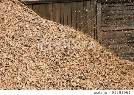 Large heaps of wood chips after pruning of trees and shrubs at the end of the winter season. Large heaps of wood chips after pruning of trees and shrubs at the end of the winter season. 91293961