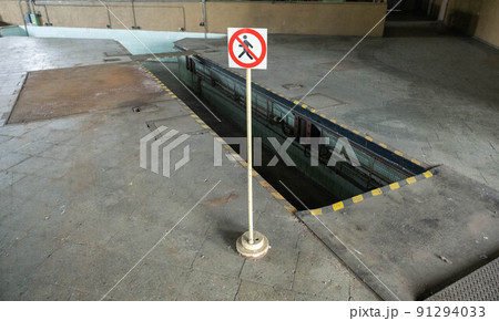 car repair pit with a warning sign, dangerous. 91294033