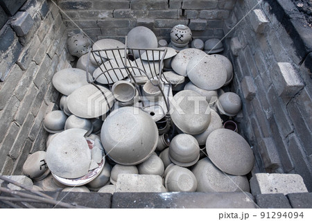 opening of a ceramic kiln, Unique handmade pots and dishes of clay getting black after firing and oxygen reducing process in wood fire kiln. Latvian national crafts. opening of a ceramic kiln, Unique handmade pots and dishes of clay getting black after firing and oxygen reducing process in wood fire kiln. Latvian national crafts. 91294094
