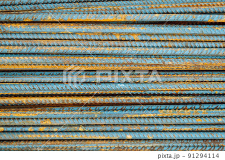 Metal fittings for reinforced concrete. Main construction materials. Background and rusty iron reinforcement rods. Red orange color of iron oxide on reinforcement bars Metal fittings for reinforced concrete. Main construction materials. Background and rusty iron reinforcement rods. Red orange color of iron oxide on reinforcement bars 91294114
