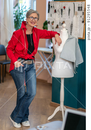 Woman touching mannequin looking at camera confidently Woman touching mannequin looking at camera confidently 91295548
