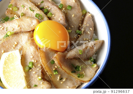 カットレモンと卵黄が乗った豚トロ丼、焼き肉丼を黒背景で俯瞰撮影 カットレモンと卵黄が乗った豚トロ丼、焼き肉丼を黒背景で俯瞰撮影 91296637