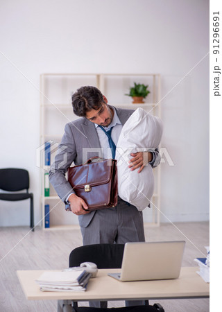 Young male employee in oversleeping concept 91296691
