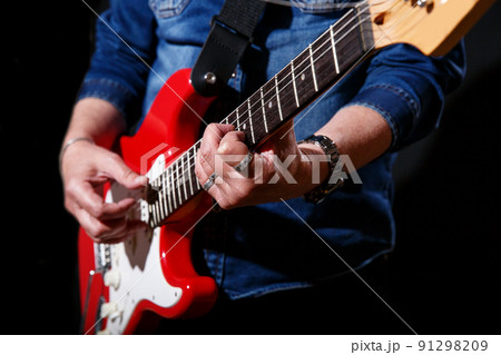 elderly man in blue denim shirt plays the electric guitar elderly man in blue denim shirt plays the electric guitar 91298209