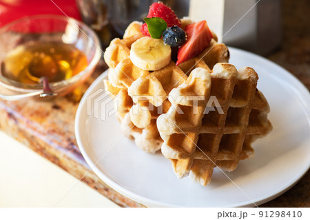 Belgian waffles, berries with honey and coffee. Breakfast concept. 91298410