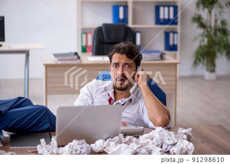 Young male employee in brainstorming concept 91298610