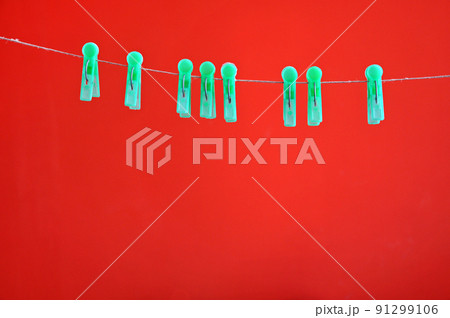 Green clothespins hanging on rope Green clothespins hanging on rope 91299106