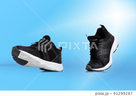Modern unisex footwear, sneakers isolated on blue background. Fashionable stylish sports casual shoes. Creative minimalistic layout with footwear. 91299287