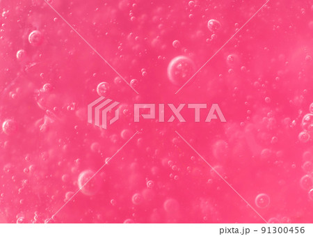 Texture of transparent pink gel with air bubbles and waves on white background. Concept of skin moisturizing, body care, and prevention of viruses. Liquid beauty product closeup. Backdrop, flat lay Texture of transparent pink gel with air bubbles and waves on white background. Concept of skin moisturizing, body care, and prevention of viruses. Liquid beauty product closeup. Backdrop, flat lay 91300456