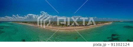 Panorama over a tropical beach taken from the water during the day Panorama over a tropical beach taken from the water during the day 91302124