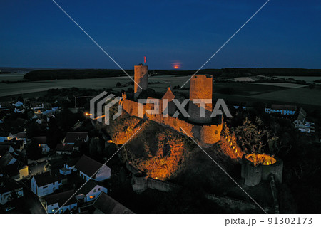 Image of illuminated Muenzenberg castle ruin in Germany in the evening Image of illuminated Muenzenberg castle ruin in Germany in the evening 91302173