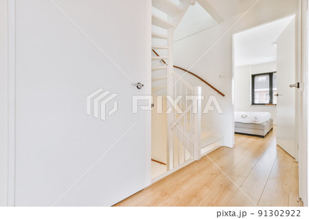 Hallway with white walls with white wooden stairs Hallway with white walls with white wooden stairs 91302922