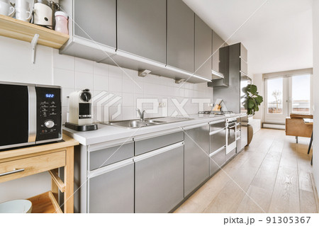 Grey silver kitchen cabinets and modern appliances 91305367