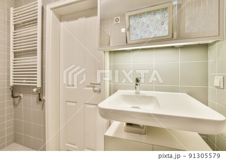 Interior of contemporary bathroom with shower, toilet and sink in minimal style in flat 91305579