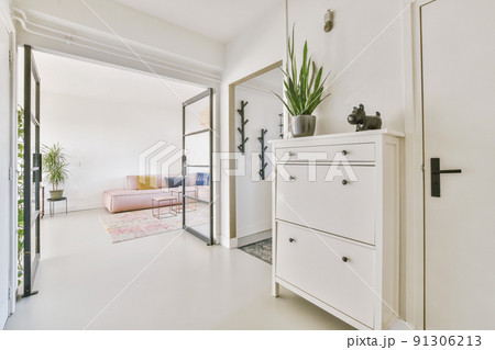 Stylish hallway with door and window to light living room in modern house Stylish hallway with door and window to light living room in modern house 91306213