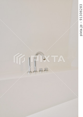 Wall mounted bath mixer tap with chrome elements in traditional design above bathtub Wall mounted bath mixer tap with chrome elements in traditional design above bathtub 91306283