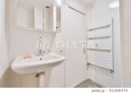 Sink with tap installed on tabletop near mirror and door in contemporary bathroom at home Sink with tap installed on tabletop near mirror and door in contemporary bathroom at home 91306474