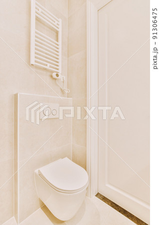 Modern toilet installed on white wall under button in light restroom at home Modern toilet installed on white wall under button in light restroom at home 91306475