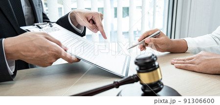 Male lawyer and Businesswoman working consulting and negotiation having team meeting at a law firm in the office Male lawyer and Businesswoman working consulting and negotiation having team meeting at a law firm in the office 91306600