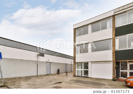 The exterior of brick buiding with corner view with cars and garages The exterior of brick buiding with corner view with cars and garages 91307175
