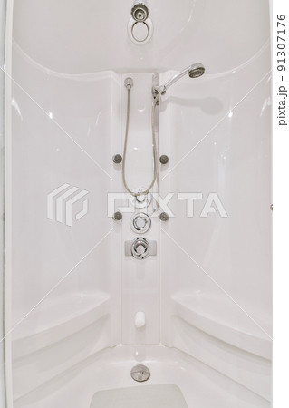 Shower tap and levers installed on white wall in modern spacious bathroom at home Shower tap and levers installed on white wall in modern spacious bathroom at home 91307176