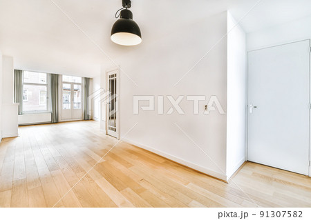 Charming design of a room with white walls and a black chandelier Charming design of a room with white walls and a black chandelier 91307582