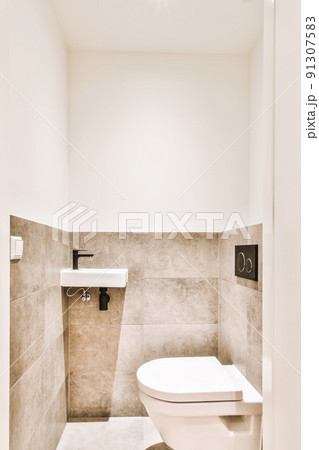 Luxurious bathroom interior with beige tiles and hanging toilet Luxurious bathroom interior with beige tiles and hanging toilet 91307583