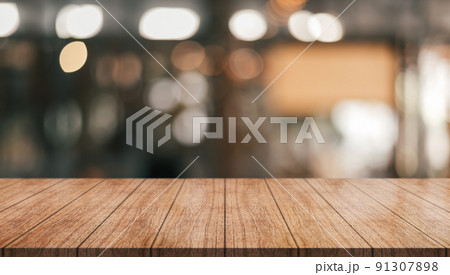 Empty wooden table top with lights bokeh on blur restaurant background.	 91307898