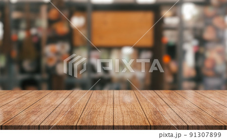 Empty wooden table top with lights bokeh on blur restaurant background. Empty wooden table top with lights bokeh on blur restaurant background. 91307899