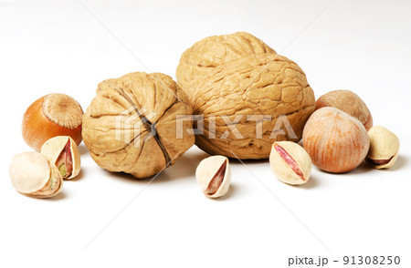 Walnuts, hazelnuts and pistachios on a white background. Nut - a source of vitamins and useful trace elements. For a healthy and vegetarian diet. 91308250