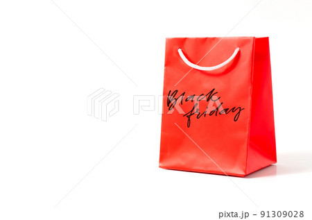Black Friday - handwritten inscription on a red gift bag. White background. The concept of discounts and sales in retail Black Friday - handwritten inscription on a red gift bag. White background. The concept of discounts and sales in retail 91309028
