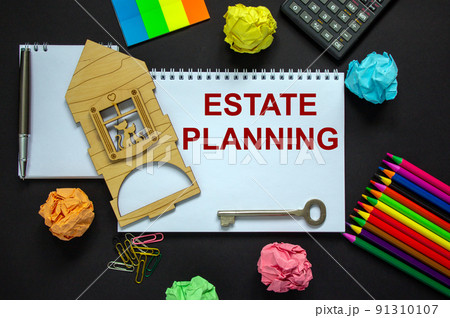 White note with inscription 'estate planning' on beautiful black background, calculator, metalic pen and key, colored paper and miniature wooden house. Business concept. 91310107