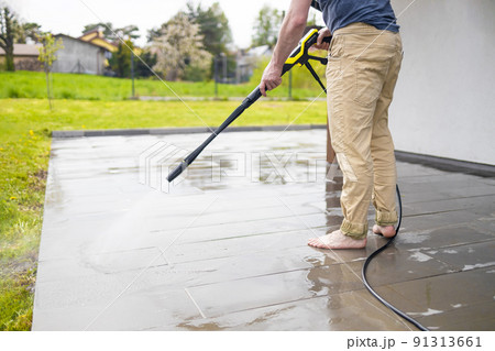 Pressure washer cleaning machine on wet concrete floor near the house build, cleaning terrace with a power washer Pressure washer cleaning machine on wet concrete floor near the house build, cleaning terrace with a power washer 91313661