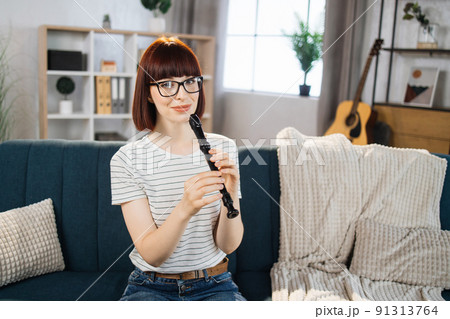 A music teacher conducts a lesson on playing a musical instrument over the Internet. 91313764