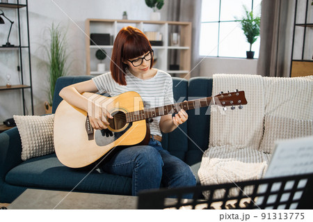 A music teacher conducts a lesson on playing a musical instrument over the Internet. A music teacher conducts a lesson on playing a musical instrument over the Internet. 91313775