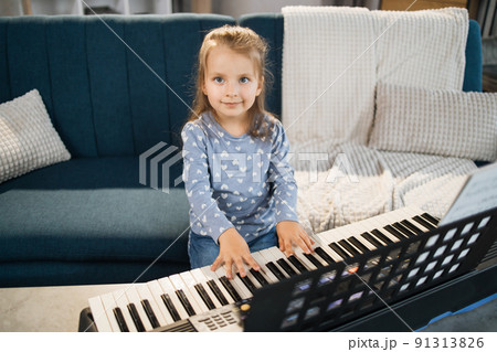 Little cute girl having lesson at piano at school of music. Little cute girl having lesson at piano at school of music. 91313826