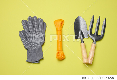 Garden tools for processing beds in the garden on a green background Garden tools for processing beds in the garden on a green background 91314850