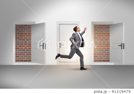 Businessman facing no exit with brick door Businessman facing no exit with brick door 91319479