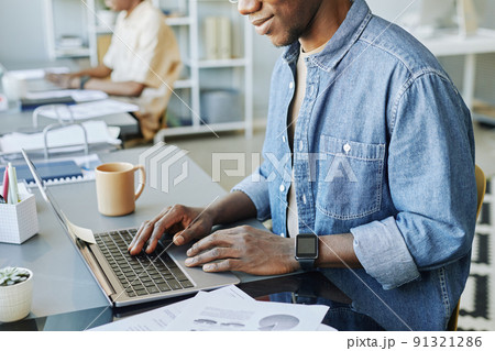 Black Man Typing at Laptop 91321286