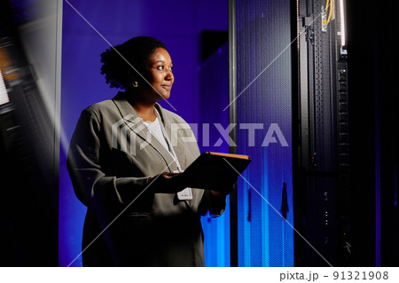 Woman Using Laptop in Server Room 91321908