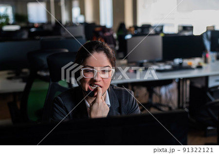 female call center employee biting her nails.  91322121